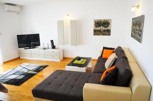 a living room with a couch and a tv at Apartments Rajic in Split