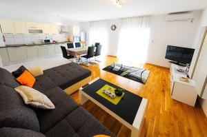 a living room with a couch and a table at Apartments Rajic in Split