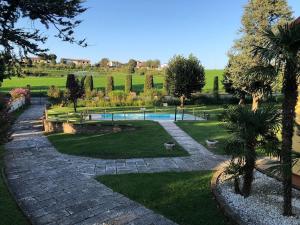 a garden with a swimming pool and trees at Borgo Segreto del Garda in Monzambano