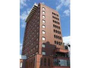 a tall red brick building with many windows at Hotel Brisbanes - Vacation STAY 64935v in Miyazaki