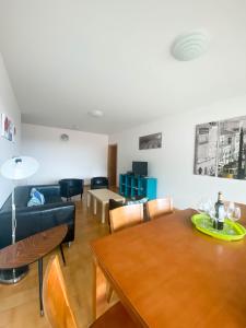 a living room with a table and a couch at Amazing Views in Machico in Machico +9 photos