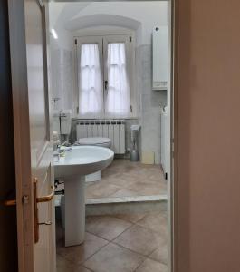 a bathroom with a white sink and a toilet at Ninì - Casa torre nel borgo in Pontremoli