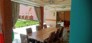 a dining room with a wooden table and chairs at House Medina Villa in Salene