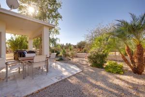 a patio with a table and chairs in a yard at Gilbert Home with Yard, Golf Course On-Site in Queen Creek