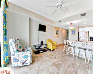 a living room with two chairs and a kitchen at Highly Desired 6th Floor 1 BR Oceanfront - There Is Only One Ocean Walk Resort 606 in Daytona Beach