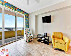 a living room with a couch and a chair and a television at Highly Desired 6th Floor 1 BR Oceanfront - There Is Only One Ocean Walk Resort 606 in Daytona Beach +35 photos
