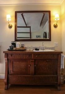 a bathroom vanity with a sink and a mirror at Marshall Slocum Inn in Newport