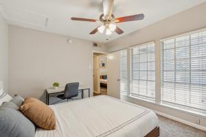a bedroom with a ceiling fan and a bed and a desk at Stratton 2415-a I Spacious 2 Bed 15 Bath in Arlington +17 photos