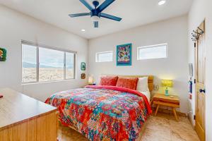 a bedroom with a bed and a ceiling fan at Margaritavilla in El Prado
