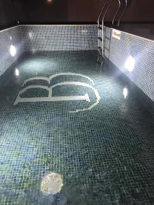 a bathroom with a tiled floor with the number at Datek's Apartments in Ulcinj