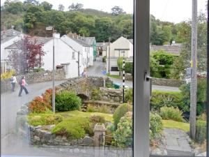 a view of a street from a window at Bridge Cottage in Braithwaite +2 photos