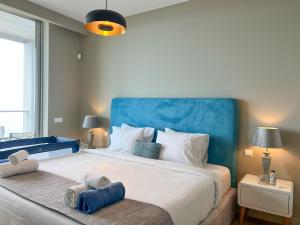 a bedroom with a large bed with towels on it at Southern Skies Apartment in Funchal +27 photos