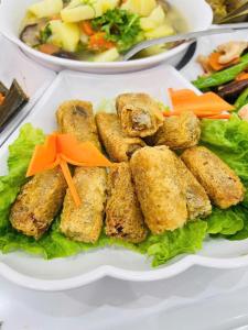 a plate of food on a table with vegetables at Ninh Binh Cozy Homestay in Ninh Binh