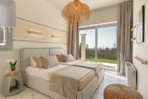 a bedroom with two beds and a large window at Natural Stone Villas Kefalonia in Trapezaki +34 photos