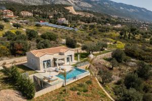 an aerial view of a villa with a swimming pool at Natural Stone Villas Kefalonia in Trapezaki