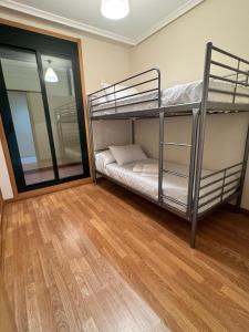 a room with two bunk beds and a mirror at Apartamento Herosa 2 Spa in San Miguel de Reinante +27 photos