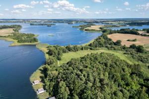 an aerial view of a river with trees and houses at slube am Krakower See in Krakow am See