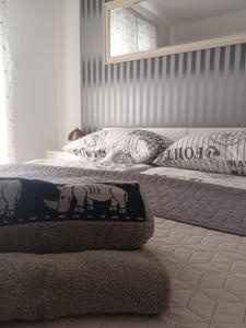 a bedroom with a bed with a blanket on it at Apartman Natalija in Privlaka