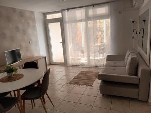a living room with a couch and a table at Apartman Natalija in Privlaka