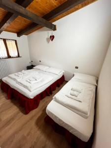 Postel nebo postele na pokoji v ubytování Silvydolomitiapartment