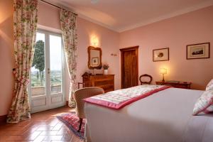 a bedroom with a bed and a large window at Casa Bellavista B&B in Cortona
