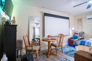 a living room with a table and chairs and a couch at Hidden Gem Luxe 1 BEDROOM & Patio in Cutler Bay