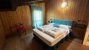 Postel nebo postele na pokoji v ubytování Silvydolomitiapartment