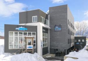 a store front with snow in front of it at Owashi Lodge in Kutchan