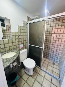 a bathroom with a toilet and a shower and a sink at Hotel Bela Vista in Salvador +27 photos