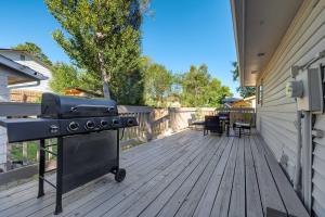 a grill on a wooden deck with a patio at Cheerful Chalet Centrally Located w BBQ Pit in Colorado Springs