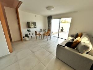 a living room with a couch and a table at Sombra de Guanapay in Teguise