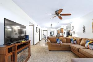 a living room with a couch and a flat screen tv at Pointe Royale 52-7, Golf, Indoor and Outdoor Pools in Branson