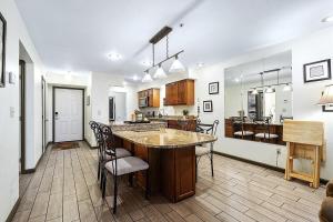 a kitchen with a large island in the middle of a room at Pointe Royale 52-7, Golf, Indoor and Outdoor Pools in Branson