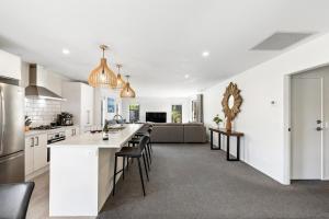 an open kitchen and living room with a large island at Mountain View - 2 Bedroom House in Queenstown