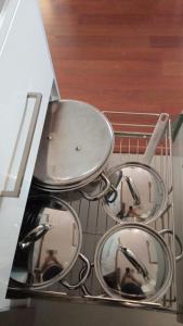 three frying pans sitting in a dish rack at Mediterraneo-Chic 120 in Benicàssim +43 photos