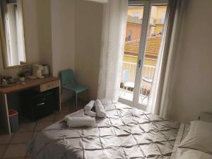 a bedroom with a bed and a desk and a window at Casamia-guest house Porto Ercole in Porto Ercole +68 photos