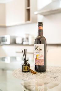 a bottle of wine sitting on top of a counter at Luxury 3 Bedroom Apartment in Sliema - Walk to Beach & Dining in Sliema