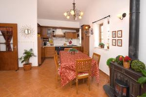 a kitchen and dining room with a table and chairs at Apartment and Rooms Artina in Vodice