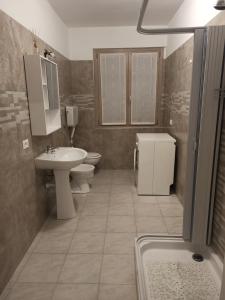 a bathroom with a sink and a toilet and a shower at Mary House in Ossimo