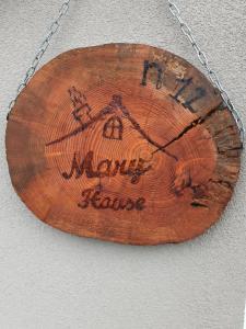 a wooden sign with a pumpkin on a chain at Mary House in Ossimo