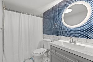 une salle de bain avec toilettes, lavabo et miroir dans l'établissement Cabana Beach #3 Condo Steps from the Beach, à Myrtle Beach