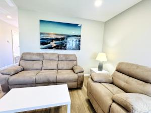 a living room with a couch and a table at Bay tree lovely one bedroom condo in Little River