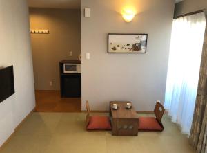 a living room with a table and two chairs at Yukari Kyoto in Kyoto +37 photos