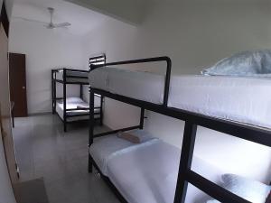a room with three bunk beds in a room at Lakefront Homestay in Taiping