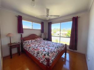 a bedroom with a bed and a window at Burrumundi - 100M To Beach - Great Water Views - Deck - Air Con - WiFi - Pool Table in Burrum Heads