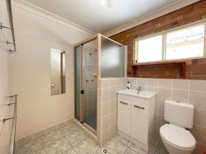 a bathroom with a toilet and a shower and a sink at Burrumundi - 100M To Beach - Great Water Views - Deck - Air Con - WiFi - Pool Table in Burrum Heads +28 photos