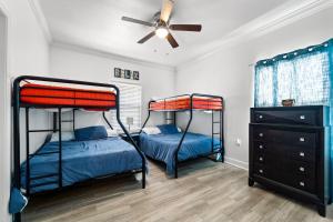 2 Etagenbetten in einem Zimmer mit Deckenventilator in der Unterkunft Newer Large Beachside 6 Bedroom House 3000 Sq Ft Sleeps 22 in Dauphin Island