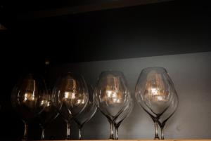 a row of wine glasses sitting on a table at 富士山望むプライベートヴィラ 900平方メートルの敷地を貸切利用 憩 ikoi Fuji サウナ 4Kシアター in Fujikawaguchiko