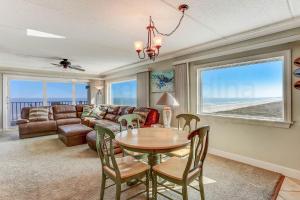 a living room with a table and a couch at Amelia South - B7 in Fernandina Beach