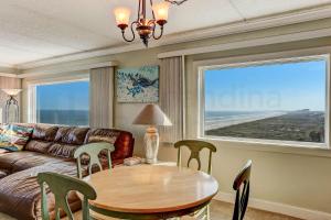 a living room with a table and a couch at Amelia South - B7 in Fernandina Beach